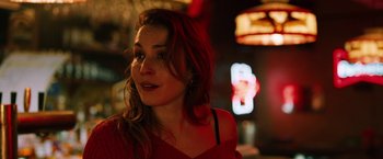 Movie still from “The Drop” (2014), directed by Michaël R. Roskam – A person wearing a red shirt; Close Up shot, Over the shoulder angle