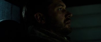 Movie still from “The Drop” (2014), directed by Michaël R. Roskam – A man's face in the dark; Close Up shot, Low angle