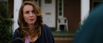 Movie still from “The Drop” (2014), directed by Michaël R. Roskam – A person with long hair; Close Up shot, Over the shoulder angle