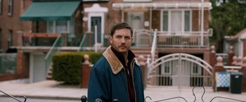 Movie still from “The Drop” (2014), directed by Michaël R. Roskam – A person wearing a jacket; Close Up shot, Over the shoulder angle