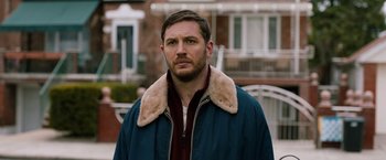 Movie still from “The Drop” (2014), directed by Michaël R. Roskam – A person wearing a jacket; Close Up shot, Over the shoulder angle