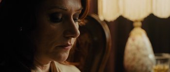 Movie still from “The Duke of Burgundy” (2014), directed by Peter Strickland – A woman's face in a chair; Close Up shot, Over the shoulder angle