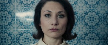 Movie still from “The Duke of Burgundy” (2014), directed by Peter Strickland – A person wearing a white shirt; Close Up shot, High angle