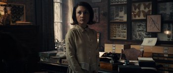 Movie still from “The Duke of Burgundy” (2014), directed by Peter Strickland – A woman standing in front of an old fashioned gramaphone; Medium shot, High angle