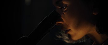 Movie still from “The Duke of Burgundy” (2014), directed by Peter Strickland – A woman's face in the dark; Extreme Close Up shot, Low angle