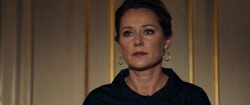 Movie still from “The Duke of Burgundy” (2014), directed by Peter Strickland – A person wearing a black shirt; Close Up shot, Over the shoulder angle