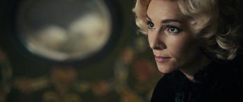 Movie still from “The Duke of Burgundy” (2014), directed by Peter Strickland – A person wearing a black shirt; Close Up shot, Over the shoulder angle