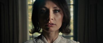 Movie still from “The Duke of Burgundy” (2014), directed by Peter Strickland – A person wearing a white shirt; Close Up shot, Low angle