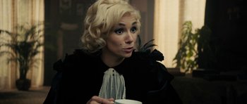 Movie still from “The Duke of Burgundy” (2014), directed by Peter Strickland – A woman with blonde hair is holding a coffee cup; Close Up shot, Over the shoulder angle