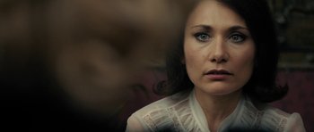 Movie still from “The Duke of Burgundy” (2014), directed by Peter Strickland – A person wearing a white shirt; Close Up shot, Over the shoulder angle