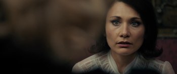 Movie still from “The Duke of Burgundy” (2014), directed by Peter Strickland – A person wearing a white shirt; Close Up shot, Over the shoulder angle