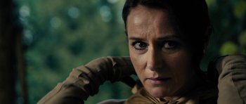 Movie still from “The Duke of Burgundy” (2014), directed by Peter Strickland – A person wearing gloves and looking at the camera; Close Up shot, Over the shoulder angle