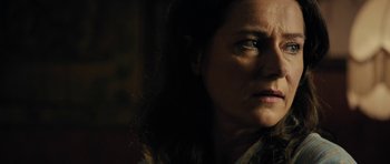 Movie still from “The Duke of Burgundy” (2014), directed by Peter Strickland – A woman's face in the dark; Close Up shot, Over the shoulder angle