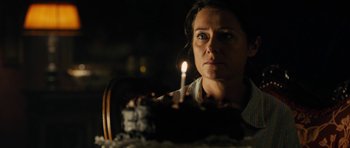Movie still from “The Duke of Burgundy” (2014), directed by Peter Strickland – A woman looking at a cake with a lit candle in it; Close Up shot, Over the shoulder angle