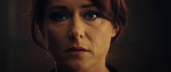 Movie still from “The Duke of Burgundy” (2014), directed by Peter Strickland – A woman's face with blue eyes; Close Up shot, Over the shoulder angle