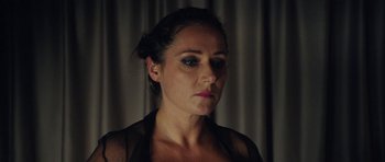 Movie still from “The Duke of Burgundy” (2014), directed by Peter Strickland – A person wearing a black shirt; Close Up shot, Over the shoulder angle