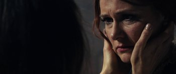 Movie still from “The Duke of Burgundy” (2014), directed by Peter Strickland – A person talking on a cell phone; Extreme Close Up shot, Over the shoulder angle