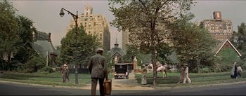Movie still from “The Eddy Duchin Story” (1956), directed by George Sidney – A man and a woman walking down a street; Extreme Wide shot, High angle