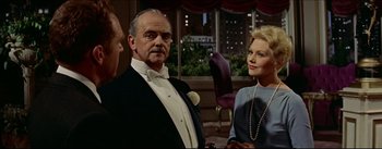 Movie still from “The Eddy Duchin Story” (1956), directed by George Sidney – A man and a woman standing next to each other in a room; Medium shot, Over the shoulder angle