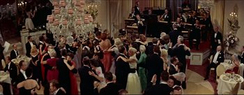 Movie still from “The Eddy Duchin Story” (1956), directed by George Sidney – A group of people in formal wear dancing in front of a crowd; Extreme Wide shot, High angle