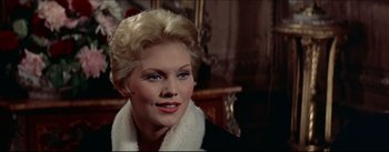 Movie still from “The Eddy Duchin Story” (1956), directed by George Sidney – A person wearing a coat; Close Up shot, Over the shoulder angle