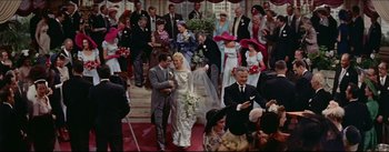 Movie still from “The Eddy Duchin Story” (1956), directed by George Sidney – A bride and groom walking down the aisle; Wide shot, High angle