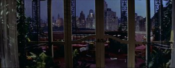 Movie still from “The Eddy Duchin Story” (1956), directed by George Sidney – A view of a city from a room with many windows; Extreme Wide shot, High angle