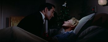 Movie still from “The Eddy Duchin Story” (1956), directed by George Sidney – A man and a woman sitting in front of a christmas tree; Medium shot, Low angle