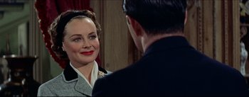 Movie still from “The Eddy Duchin Story” (1956), directed by George Sidney – A man and a woman looking at one another in front of a mirror; Close Up shot, Over the shoulder angle