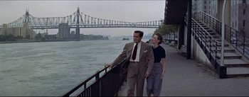 Movie still from “The Eddy Duchin Story” (1956), directed by George Sidney – A man and a woman walking along a bridge; Wide shot, High angle