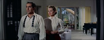 Movie still from “The Eddy Duchin Story” (1956), directed by George Sidney – A man and a woman standing next to each other in a room; Medium shot, Low angle