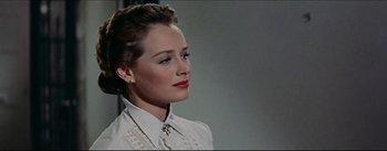 Movie still from “The Eddy Duchin Story” (1956), directed by George Sidney – A woman in a white shirt is looking to her left; Close Up shot, Low angle