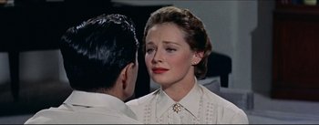 Movie still from “The Eddy Duchin Story” (1956), directed by George Sidney – A man and a woman are looking at one another; Close Up shot, Over the shoulder angle