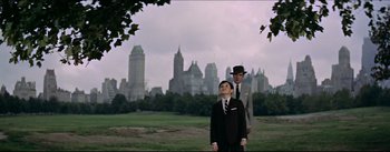 Movie still from “The Eddy Duchin Story” (1956), directed by George Sidney – Two men in suits and hats standing in front of a city skyline; Wide shot, Low angle