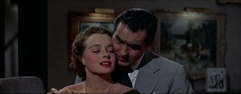 Movie still from “The Eddy Duchin Story” (1956), directed by George Sidney – A man and a woman are kissing in a room; Close Up shot, Low angle