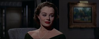 Movie still from “The Eddy Duchin Story” (1956), directed by George Sidney – A person wearing a necklace; Close Up shot, Over the shoulder angle