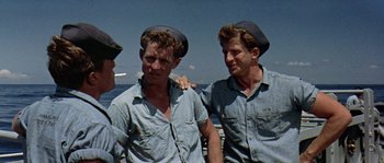 A group of men standing next to each other on a boat