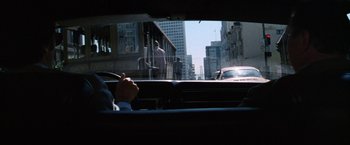 Movie still from “The Enforcer” (1976), directed by James Fargo – A view from a car window of a city street; Wide shot, Over the shoulder angle