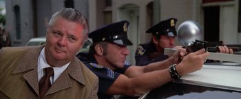 Movie still from “The Enforcer” (1976), directed by James Fargo – A group of men in police uniforms sitting next to each other; Close Up shot, Low angle