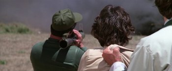 Movie still from “The Enforcer” (1976), directed by James Fargo – A man taking a picture of another man holding a camera; Close Up shot, Over the shoulder angle