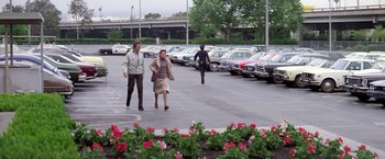 Movie still from “The Enforcer” (1976), directed by James Fargo – Two women are walking through a parking lot; Extreme Wide shot, High angle