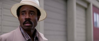 Movie still from “The Enforcer” (1976), directed by James Fargo – A person wearing a hat; Close Up shot, Low angle