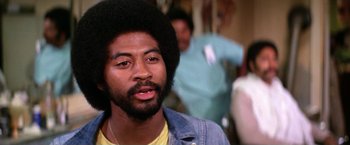 Movie still from “The Enforcer” (1976), directed by James Fargo – A person wearing a jacket; Close Up shot, Low angle