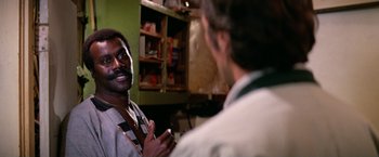 Movie still from “The Enforcer” (1976), directed by James Fargo – Two men are talking in a kitchen; Close Up shot, Over the shoulder angle