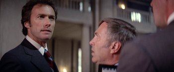 Movie still from “The Enforcer” (1976), directed by James Fargo – A man and a woman talking to each other; Close Up shot, Low angle