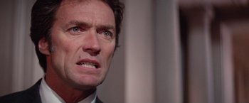 Movie still from “The Enforcer” (1976), directed by James Fargo – A person with a frowning face; Close Up shot, Low angle