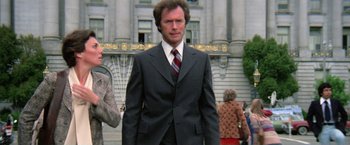 Movie still from “The Enforcer” (1976), directed by James Fargo – A person wearing a suit and tie; Medium shot, Low angle