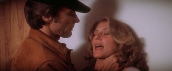 Movie still from “The Enforcer” (1976), directed by James Fargo – A man and a woman face each other in a room; Close Up shot, Overhead angle