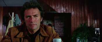 Movie still from “The Enforcer” (1976), directed by James Fargo – A person with a cup of coffee; Close Up shot, Low angle
