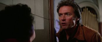 Movie still from “The Enforcer” (1976), directed by James Fargo – A person looking at a mirror; Close Up shot, Over the shoulder angle